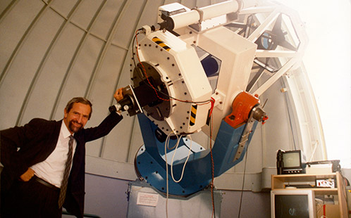 Open Day - Publicity Photograph - Professor Chris Duke standing near a telescope inside the Werrington Observatory 1997 (P3640)