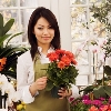 A young Asian florist in her flower retail shop