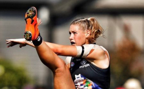 Tayla Harris AFLW in action kicking a football