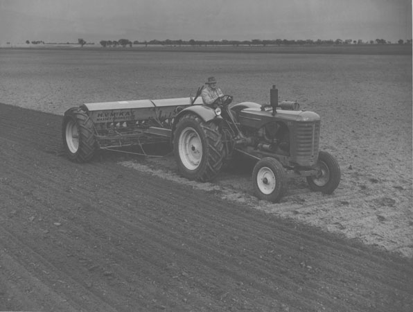 Ploughing a field with a tractor pulling farm machinery supplied by HV McKay Massey Harris Pty Ltd [Hawkesbury Agricultural College (HAC)]