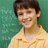 Teenage boy with a blackboard behind him with mathematical questions