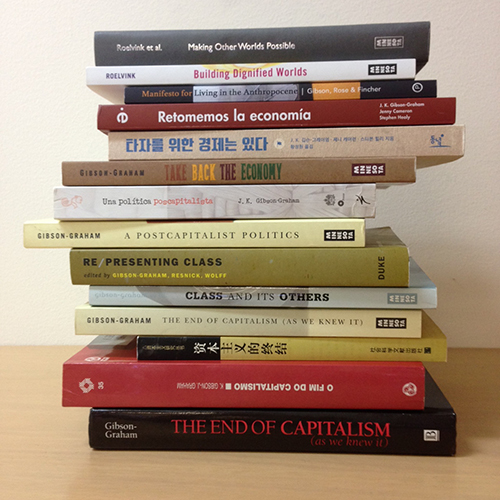 A stack of 14 books relating to post-capitalist possibilities