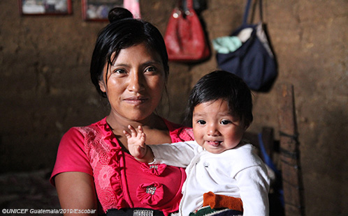 A mother, facing the camera, holds her baby. Photo ©UNICEF Guatemala/2019/Escobar.