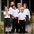 A group of young children in school uniforms standing together.