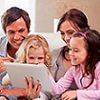 Thumbnail image of a family looking at a laptop 