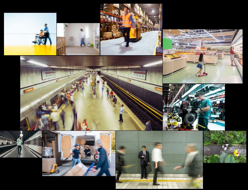 This image is an arrangement of ten smaller images in different sized boxes. Most of the people in the photos are blurred and indistinct, indicating movement. The smaller images are: a person in a wheelchair being pushed by another person; a person walking in a room that may be a child’s nursery; a person and a machine in the aisle of a warehouse; a woman and a child on a scooter in the fruit and vegetable section of a supermarket; a person using a machine in a factory; a bird’s eye view of two people passing each other on a garden path; men dressed in business attire walking past each other including one man who has stopped to look at the mobile phone in his hand; a delivery worker crouching in the back of a loaded van, while other delivery workers move trolleys loaded with boxes in front of the van’s open doors; a woman standing on a platform as a train moves past; and two dozen or so commuters milling around on a different platform, some of whom are boarding a train while others wait for another train on the opposite platform.