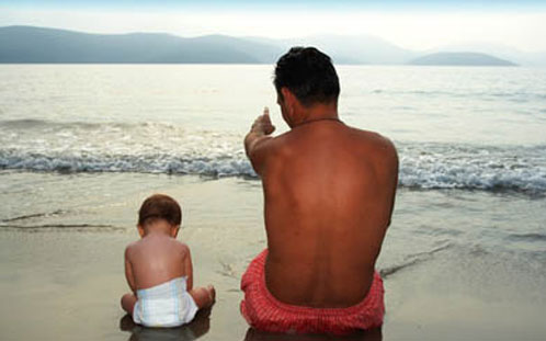 Man and baby on beach