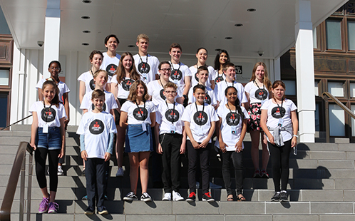 A group of 21 young people on the steps to the Museum of Australian Democracy