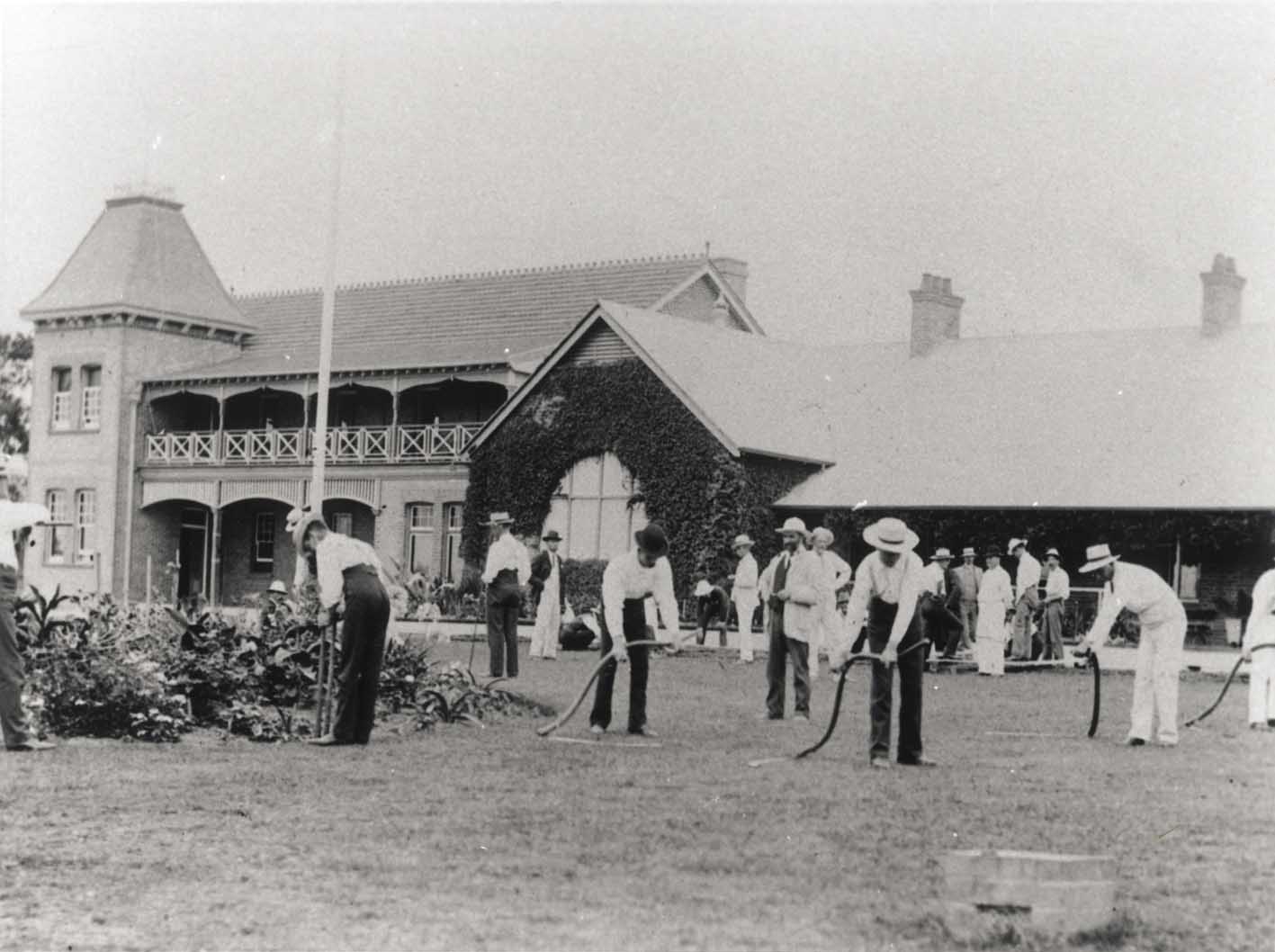 Students scything front lawn under instruction [Hawkesbury Agricultural College (HAC)]