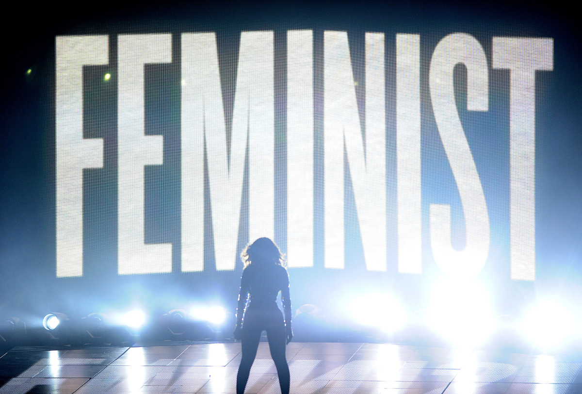 Image of Beyonce at the VMA's, her silhouette in front of text that reads 'Feminist