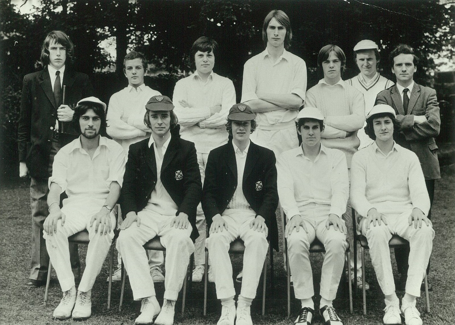 Black and white image of young men's cricket group posing for a photo