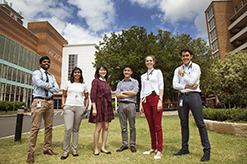 Six medical students from a range of different cultural backgrounds standing together on the campbelltown campus lawn