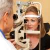 A woman undertaking an eye exam