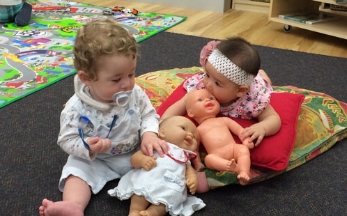 Babies play with dolls
